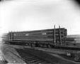 Load of log poles for Page & Hill Company on railroad car, 1913