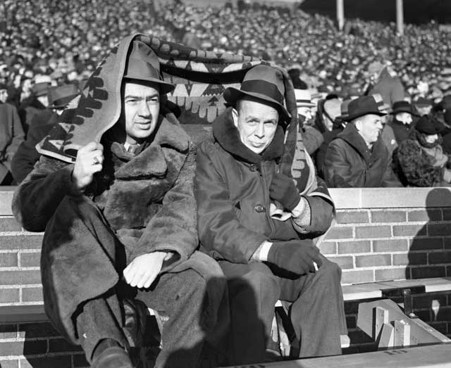Photo of cold people watching football.
