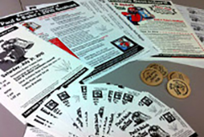 Flyers are fanned out on a desk.