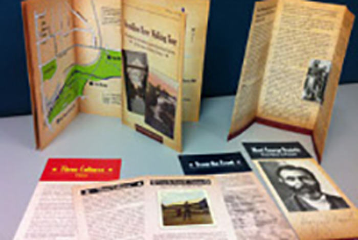 Brochures laying and standing on top of a desk nicely.
