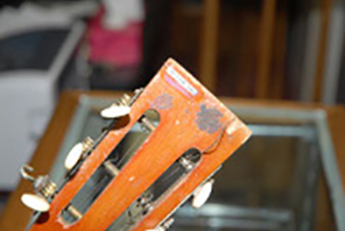 A close-up of a guitar with number on the wood end.