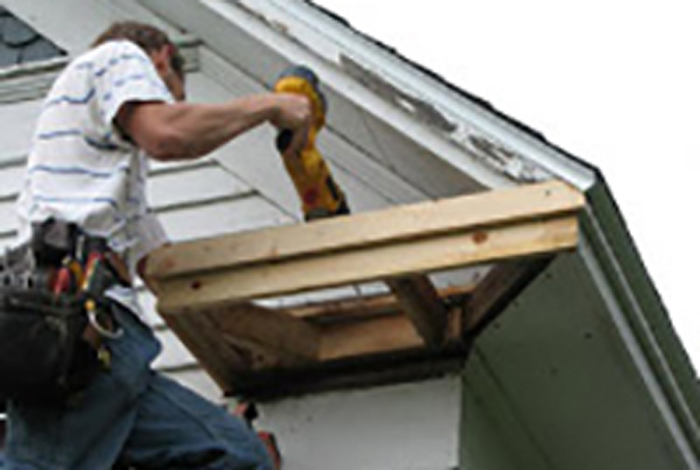 Worker repairing a roof.