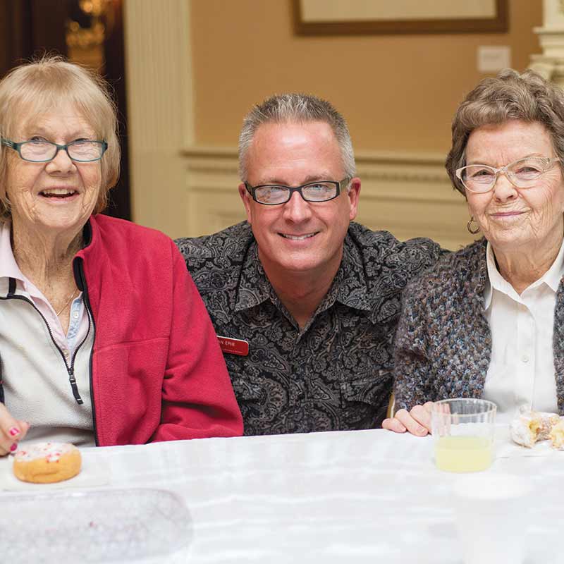 Man sitting between two women