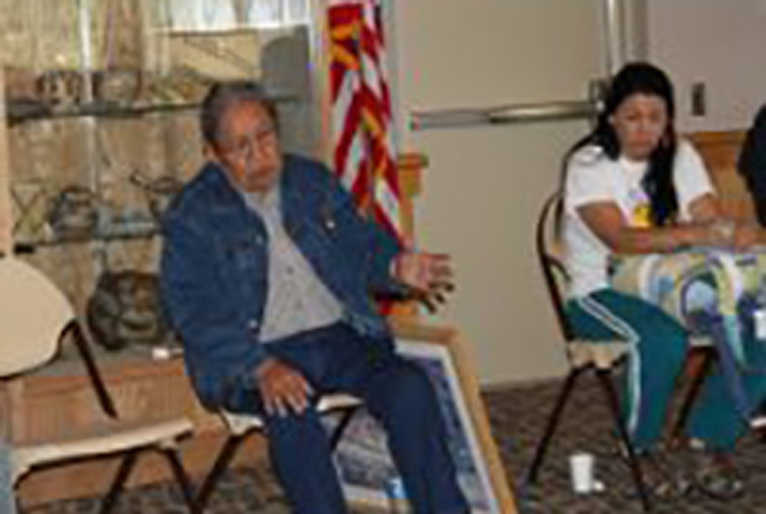 A seated woman is talking.
