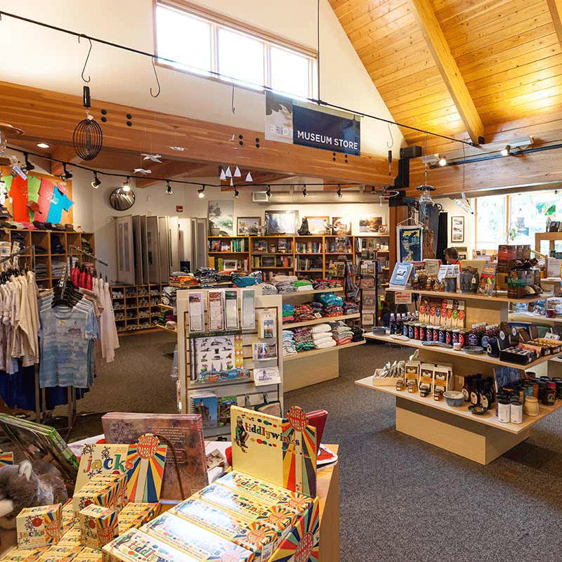 Racks of clothes and assorted items on shelves in the gift shop