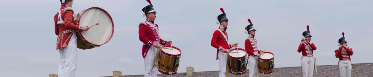 Costumed guides playing the drums.