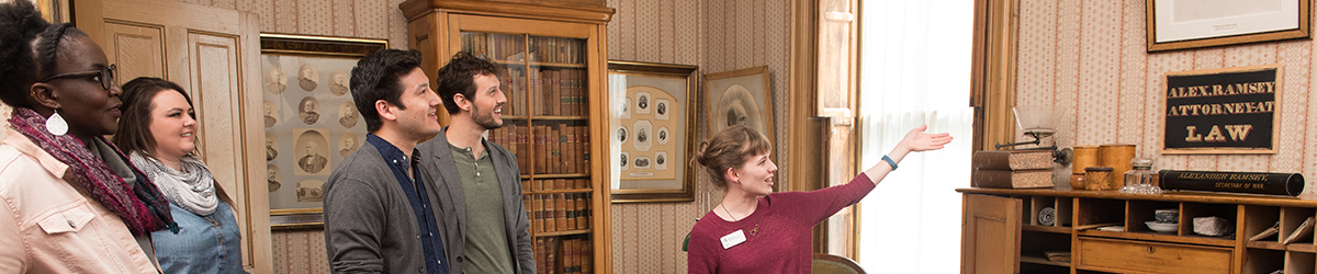 Woman leading tour group through Alexander Ramsey's office