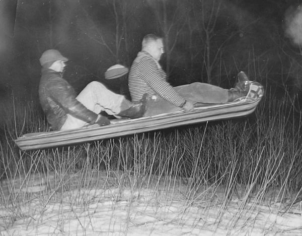 1957-tobogganauts to men flying in midair on a toboggan