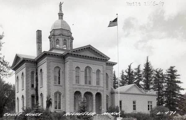 Exterior of the Olmsted County Courthouse. On the photo are the typed words Built 1866-67