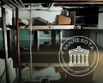 AI Illustration-Flooded basement with boxes floating in water with MAHR logo superimposed over the top