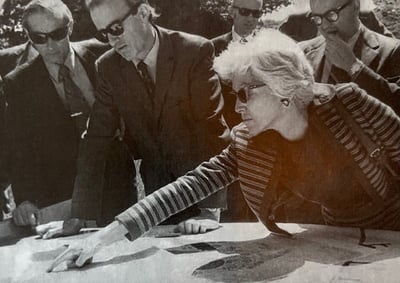 Elizabeth Close point at detail in plan while several men look on