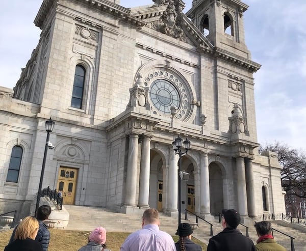 7 people looking at front exterior of St. Marys Basilica