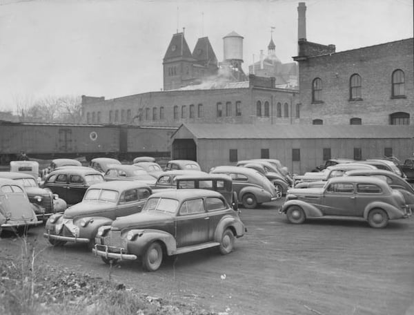 1941 photo of cars in forground and Minneapolis Brewing Company buildings in background