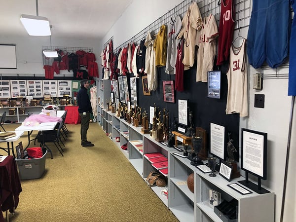 Man staring at historic items on display in school room at Milan High School3