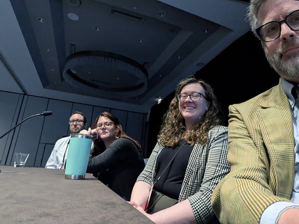 A Camera selfie of looking up at four people at a table