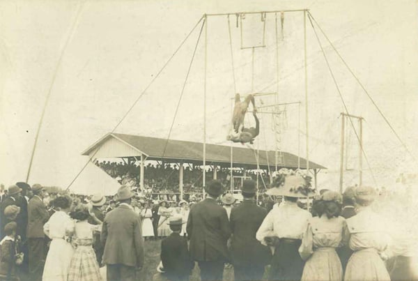 Early picture of Dodge County Fair. A trapeze act ca.1900