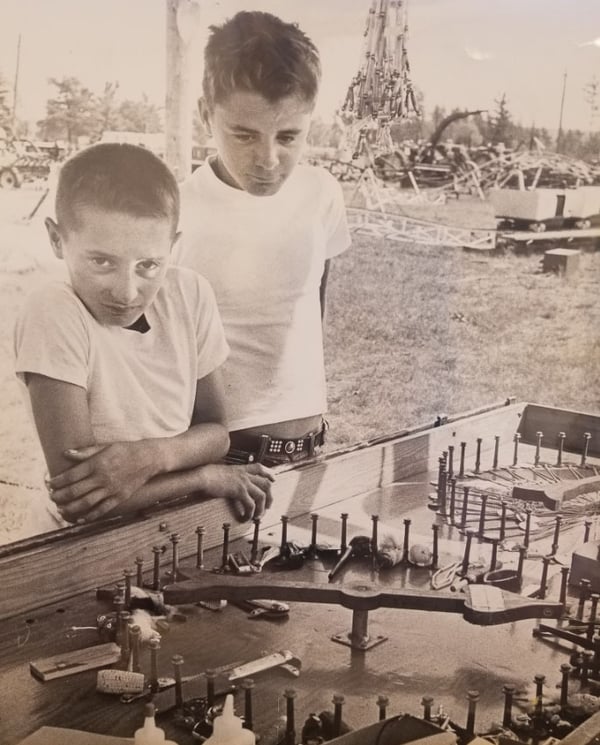 Boys looking over a novelty stand at fair