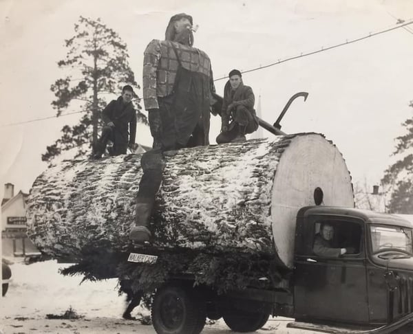 Paul Bunyan Float in 1938-Giant log on a truck with two men on either side of a sculptural effigy of Paul Bunyan riding astride the log