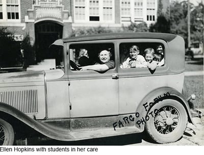 Ellen Hopkins in car with students in her care. Fargo Forum Photo written on photo
