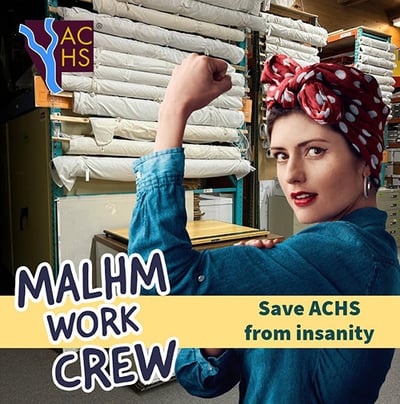 MALHM WORK CREW-A woman in a blue denim shirt and red polka dot bandana poses in front of fabric rolls on shelves