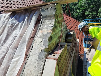 Installation of through wall flashing and brick reconstruction on west elevation