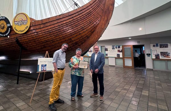 Three people with one holdig a certificate