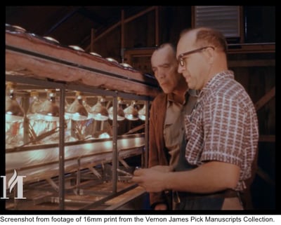 A Screenshot of 8mm movie showing two men looking over equiptment