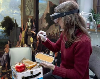 Conservator painting peanutbutter on painting