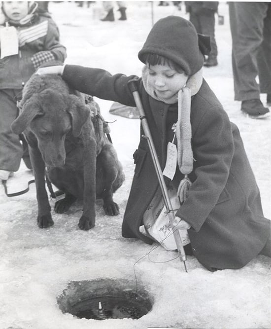 LHN-Little girl with her dog at ice fishing contest in 1956