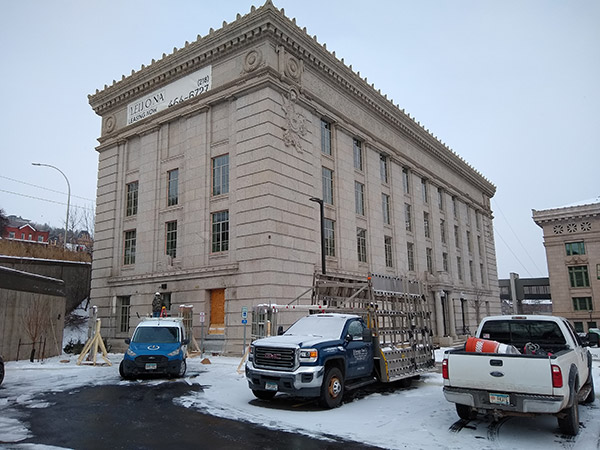 Saint Louis County Jail renovation showing exterior of building with cars of construction businesses in front