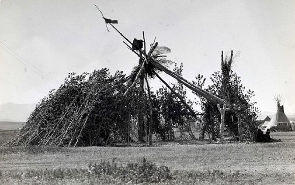 Black and white photograph of a Native American medicine lodge of the Blackfeet tribe. ca. 1940