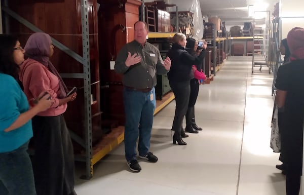 Man giving tour of 3D MNHS collections area to a group of people
