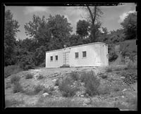 Black and white photograph of boxcar chapel in Swede Hollow, 1949.