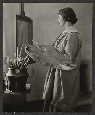 Black and white photograph of Elsa L. Jemne working at an easel, 1922.