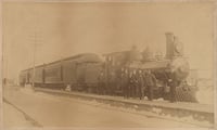 St. Paul and Duluth Railroad Company train and several railroad men, including John Wesley. Blair was an African American porter on the Eastern Minnesota train that rescued hundreds of people from the fire in Hinckley. He was honored as one of the heroes. He is second from the right in the photograph.