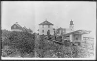 Black and white photograph of Split Rock Light Station and a tram car c.1916.