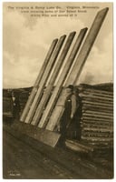 Five wooden boards lean against a wooden frame, flanked by two men.