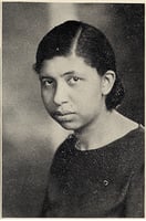 Three-quarters head-and-shoulders view of a woman with her hair parted on the side.