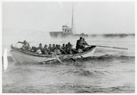 A rowboat full of people navigates with outstretches oars towards a ship in the background.