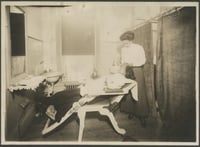 Photograph of Smith and a client at the Olive Hair Store, 1913.