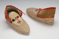 Color image of Dakota beaded and ribbonwork moccasins, made by Sarah Good Thunder (Dakota), 1904. Inscribed: “Made by Mrs. Good Thunder for Mrs. Whipple 1904.