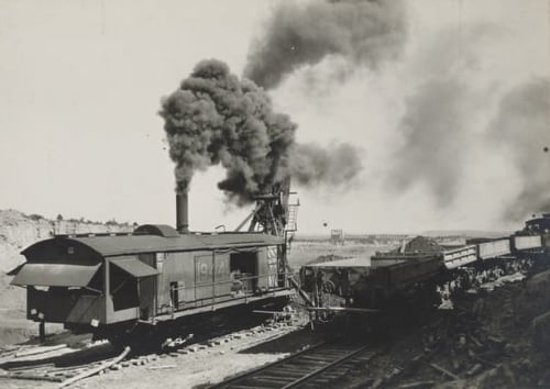 Oliver Mining Company steam-powered shovel near Hibbing, 1919. A shovel removes overburden, the rock and soil that covers the ore body, so that miners can access the ore from the open pit.