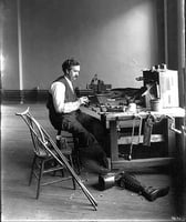 Black and white photograph of E. H. Erickson making artificial limbs, 1904.