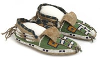Pair of sinew-sewn leather moccasins with a rawhide sole. Made by Dakota Indians in the late nineteenth or early twentieth century.