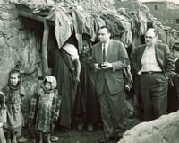 Black and white photograph of the executive director of the United Jewish Federation Council of St. Paul and the executive director of the Jewish Federation Council of Kansas City visit a home in Ourika, Morocco during a tour of conditions of Jews in North Africa, undated.