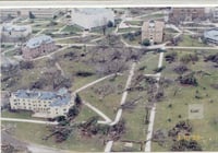 Color image of tornado damage in St. Peter, Minnesota, 1998. Image shows trees down and damage to a number of buildings.