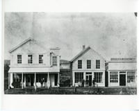 Black and white photograph of Van Campen store and Scofield's drug store, 1883.