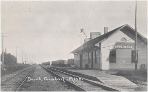 Black and white postcard showing the Great Northern Railway Depot and a grain elevator behind the depot in Clontarf, c.1880s.