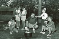 Black and white photograph of campers cooking outdoors at Dick Butwin Day Camp, 1967.
