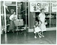 Employee Dick Liecting pushing a grocery cart for two shoppers at the Red Owl Store, Southdale Mall, Edina.